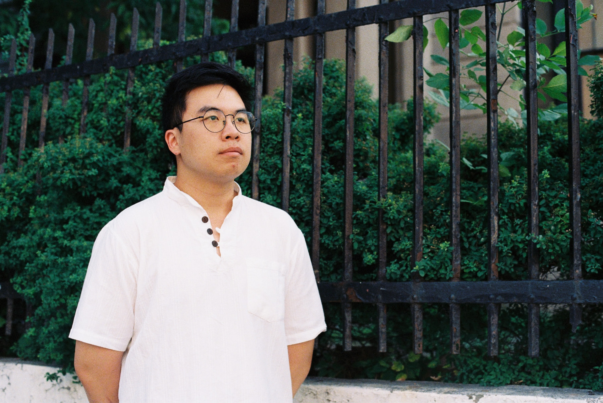 Tanakrit Tongnopnua, Thai jazz pianist, outdoors in a white shirt